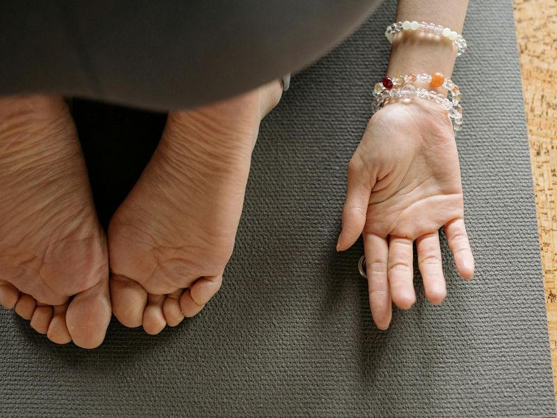Detailed close-up of hands and feet during yoga alignment