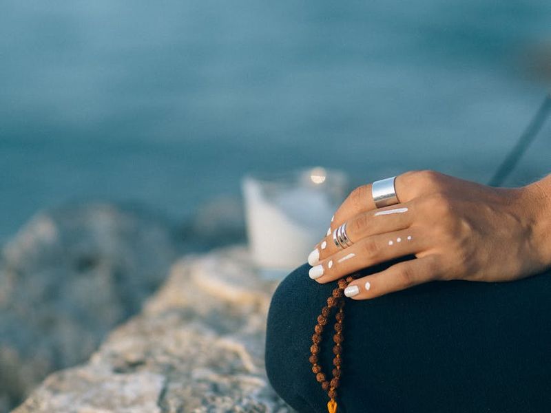 Person practicing deep meditative breathing in a minimalist room