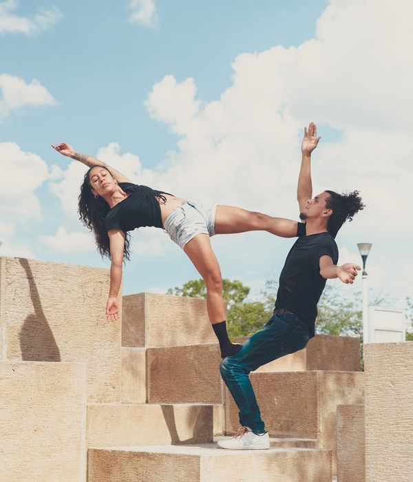 Woman performing a balanced yoga pose outdoors during sunrise